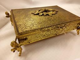 ANTIQUE GOLDEN METAL MIRRORED JEWELRY BOX WITH FLANKING CHERUBS