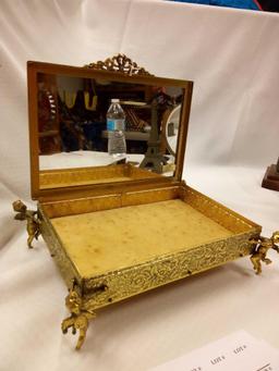 ANTIQUE GOLDEN METAL MIRRORED JEWELRY BOX WITH FLANKING CHERUBS