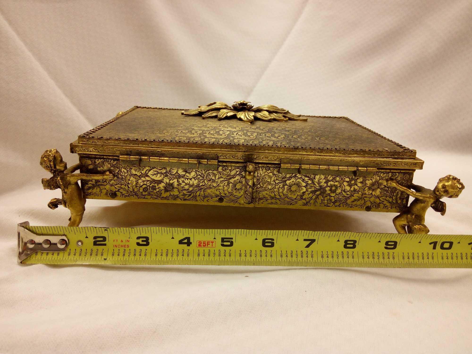 ANTIQUE GOLDEN METAL MIRRORED JEWELRY BOX WITH FLANKING CHERUBS