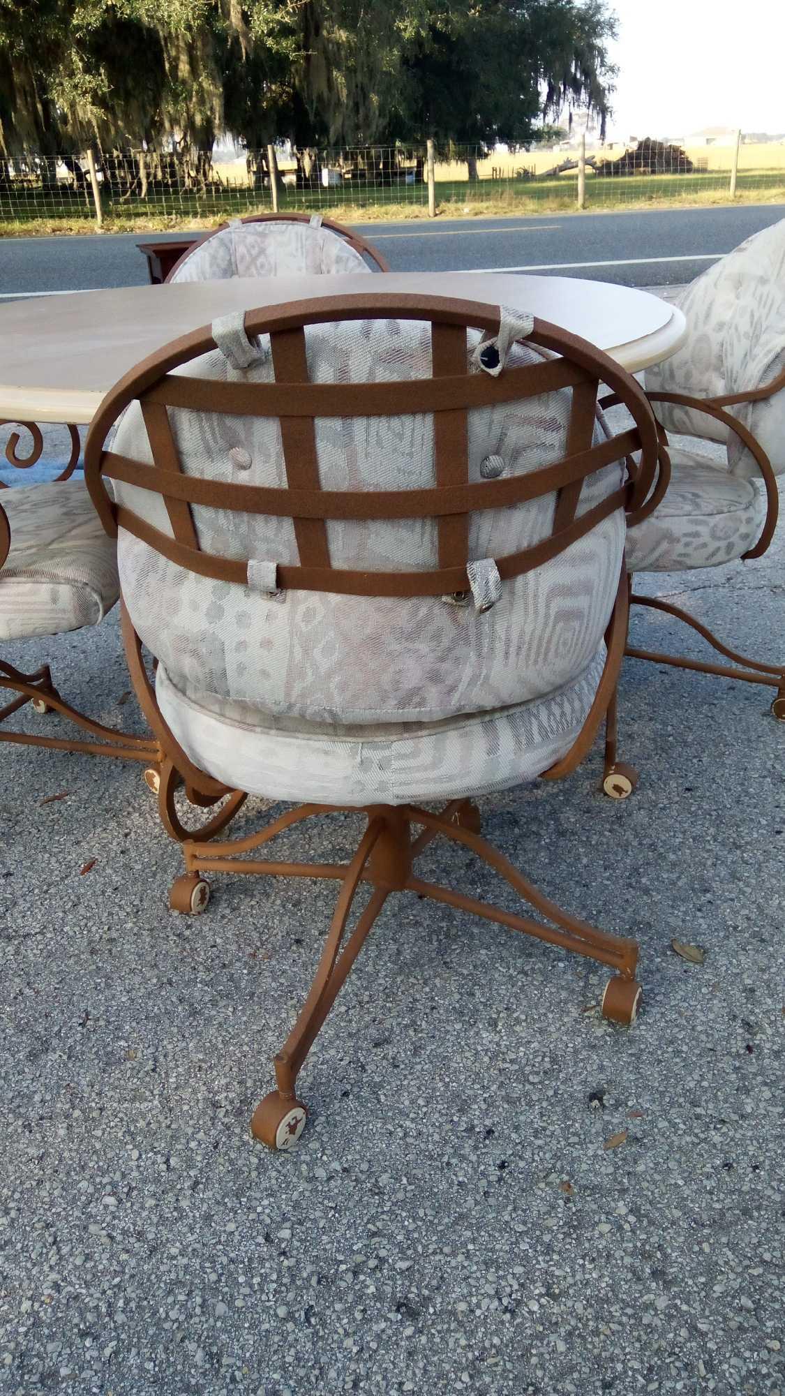 Wrought Iron Kitchen / Patio Table, Swirled Legs, with four chairs on casters