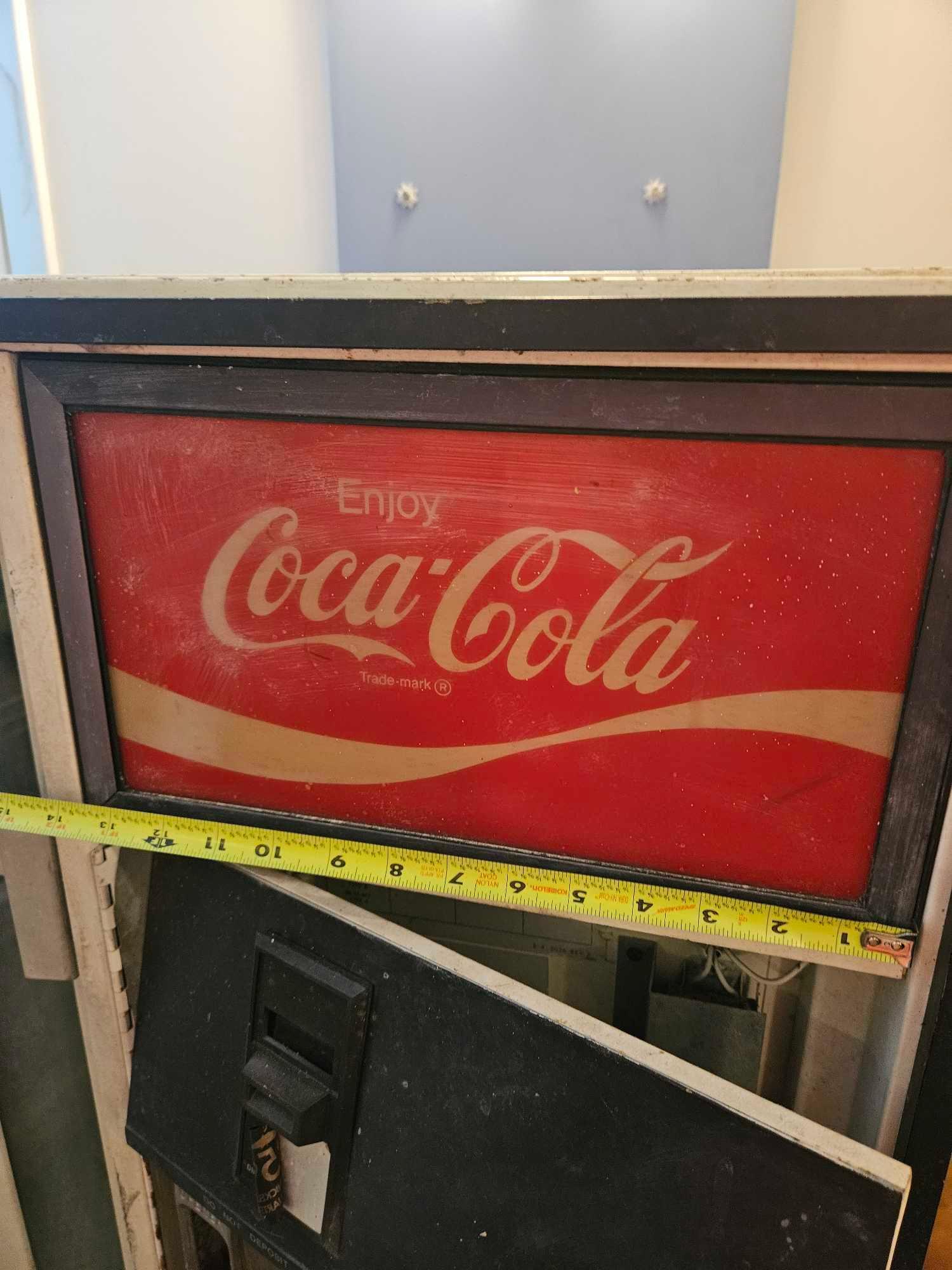 Very vintage Coca-Cola bottle dispensing machine.