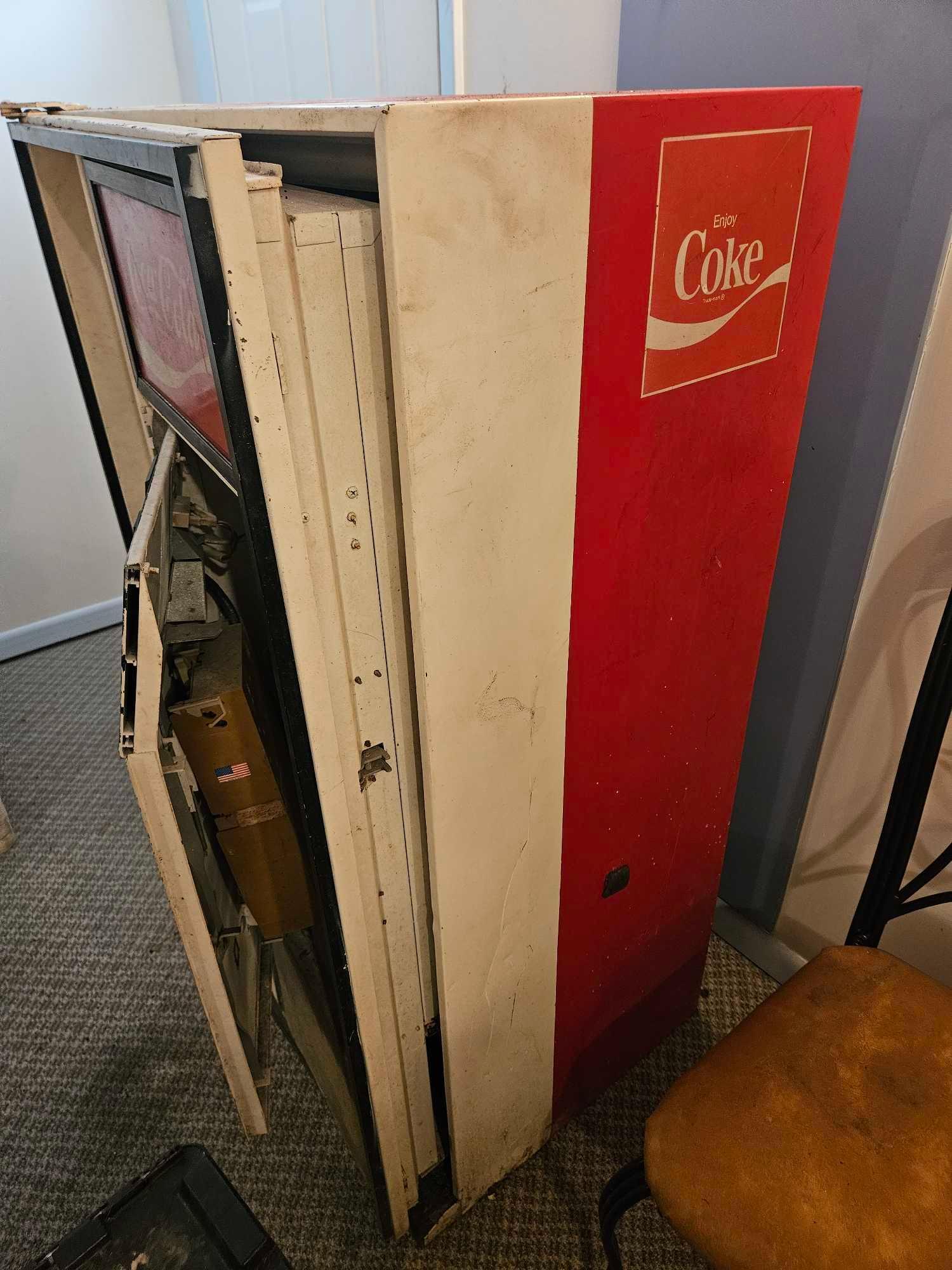 Very vintage Coca-Cola bottle dispensing machine.