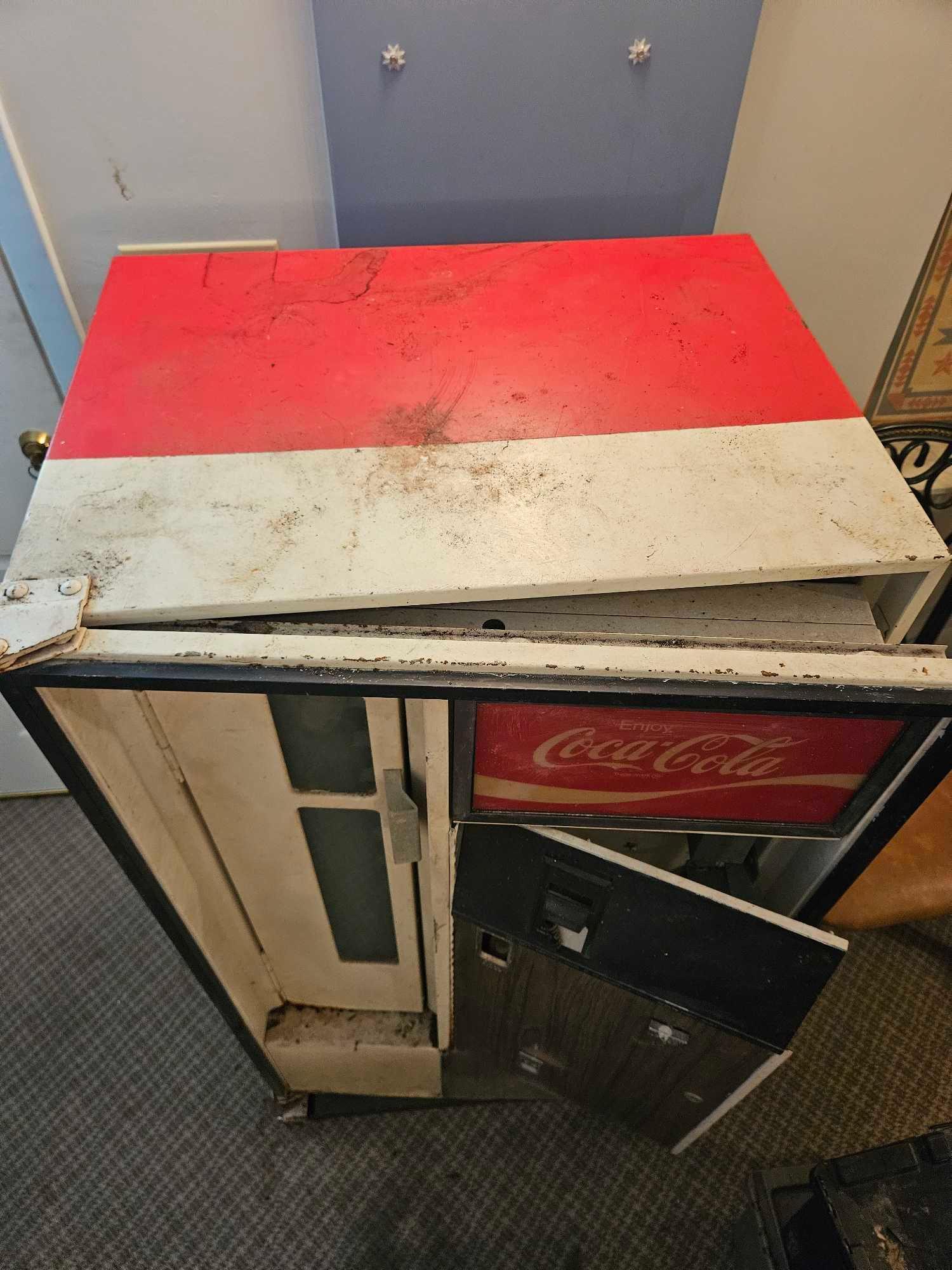 Very vintage Coca-Cola bottle dispensing machine.