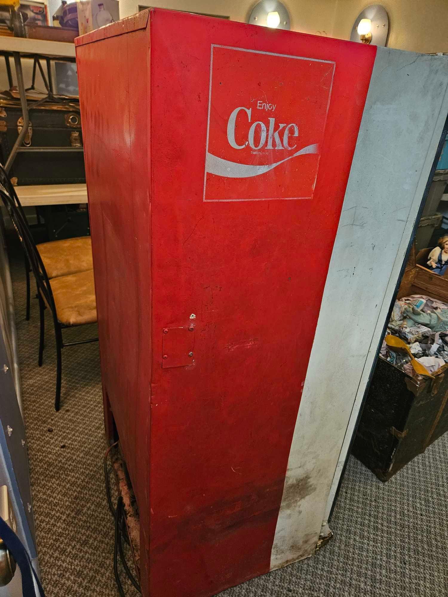 Very vintage Coca-Cola bottle dispensing machine.