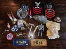 Box of collectible tinies including badges, sports, watches, toys.