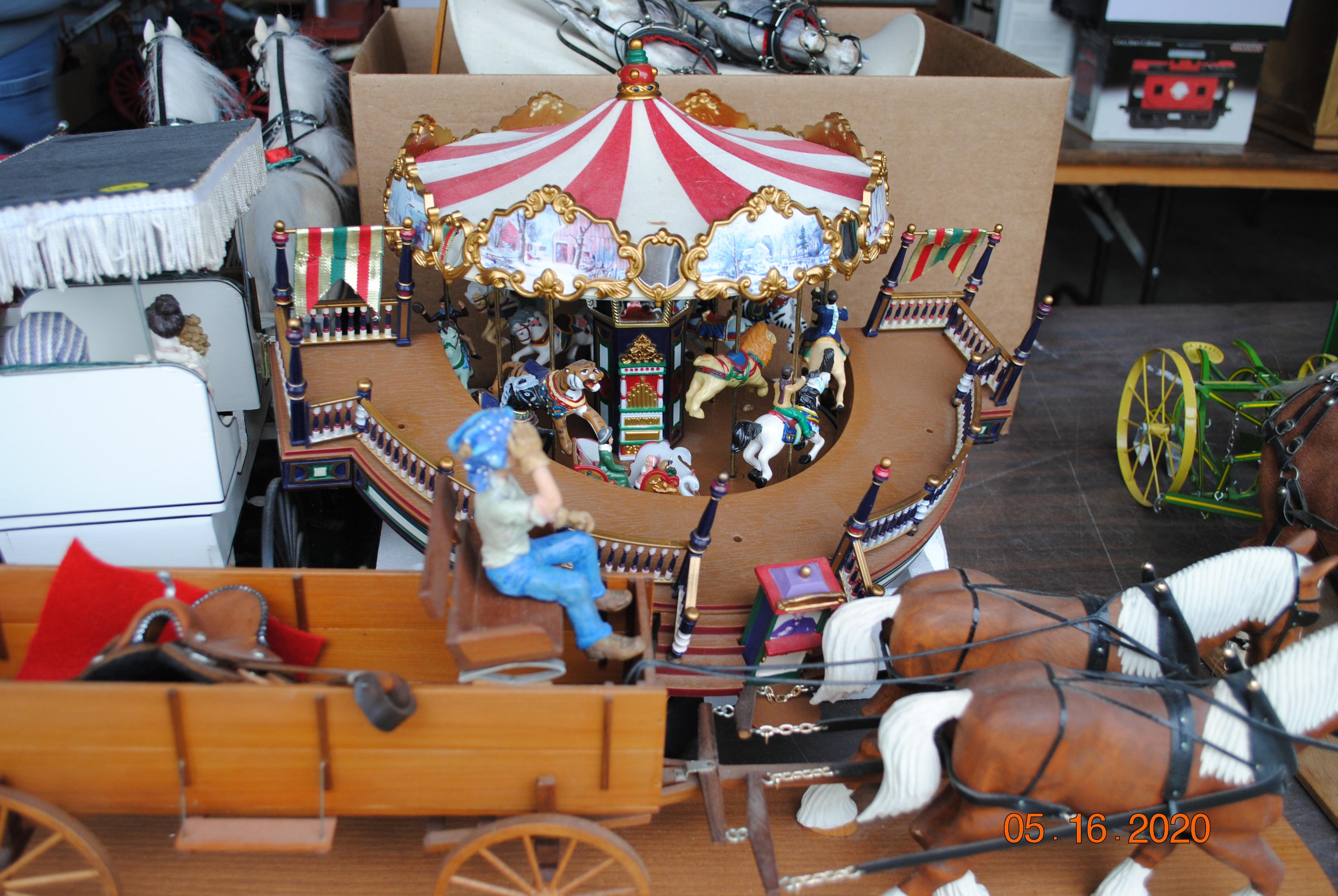 Several horses with wagons, carousel holiday around, Christmas buggy, circus wagon