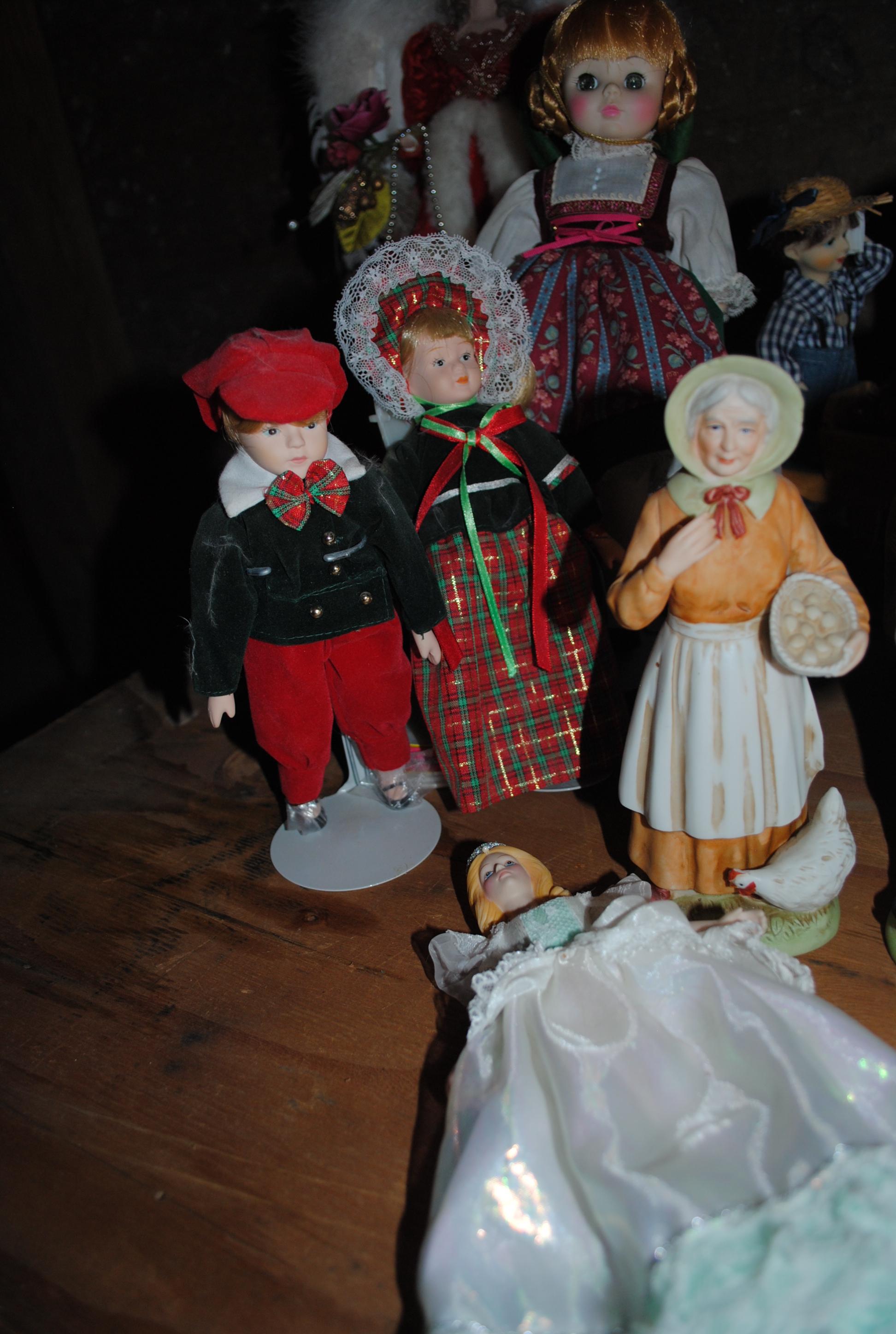 22 Assorted porcelain/ceramic dolls on stands