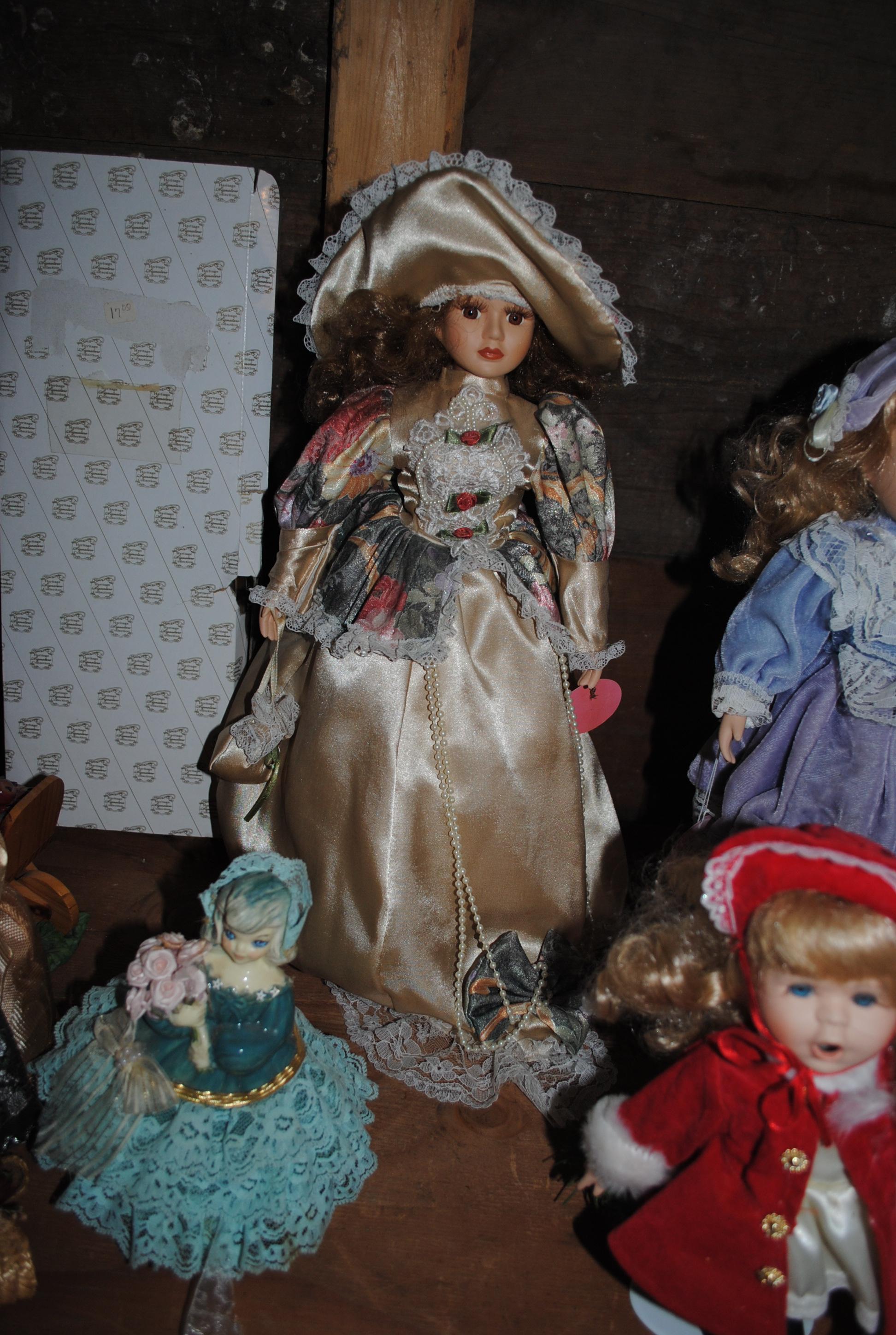 22 Assorted porcelain/ceramic dolls on stands