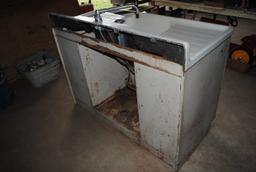 White porcelain sink & steel wheel encased in wood frame