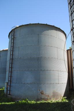 Butler 7-ring grain bin, approx. 18' high and 18' wide, has side ladder. The bottom ring is half bur