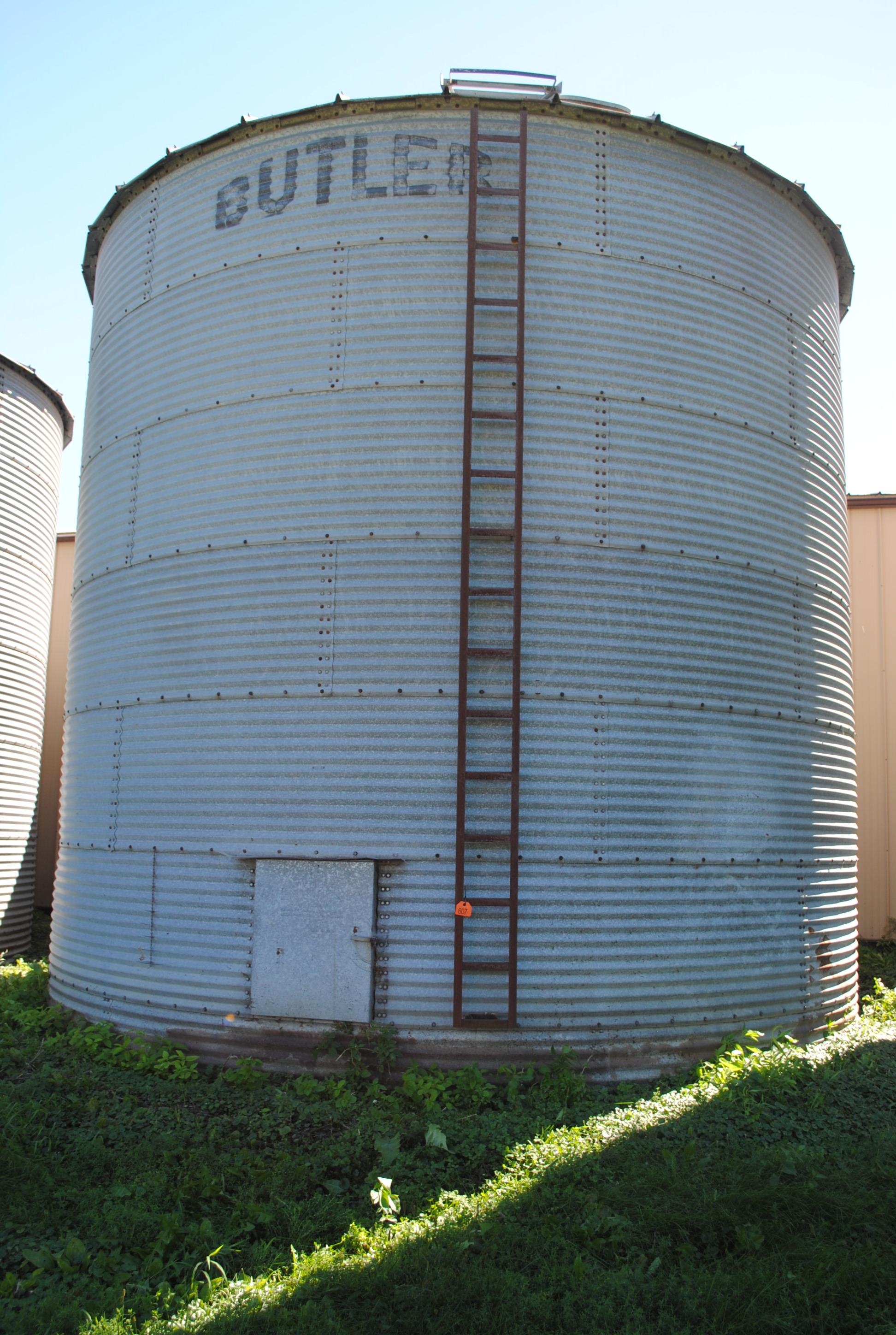 Butler 7-ring grain bin, approx. 18' high and 18' wide, has side ladder. The bottom ring is half bur