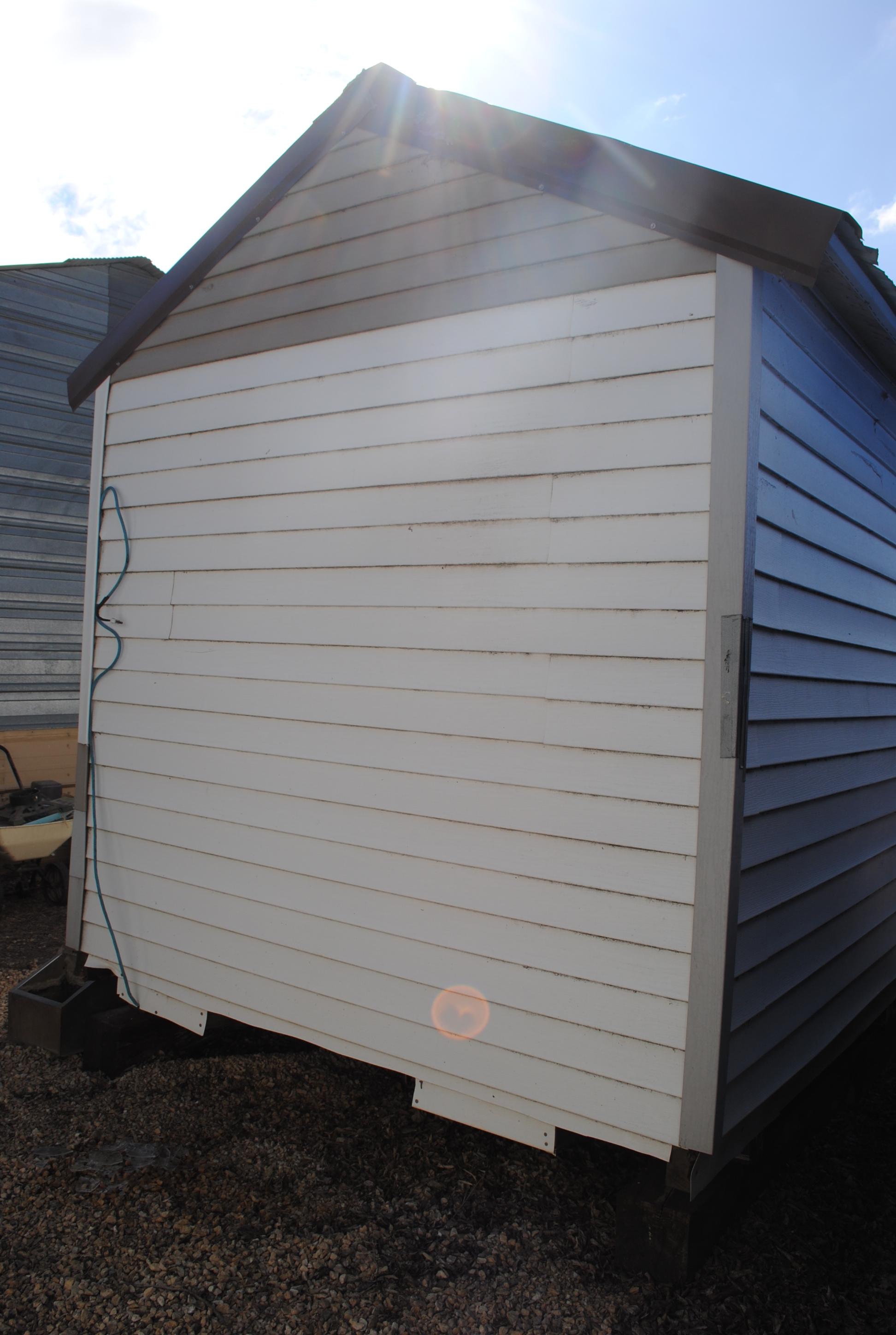 White Vinyl Sided Shed approx. 13'x7' with door on one end. Buyer is responsible for removal.