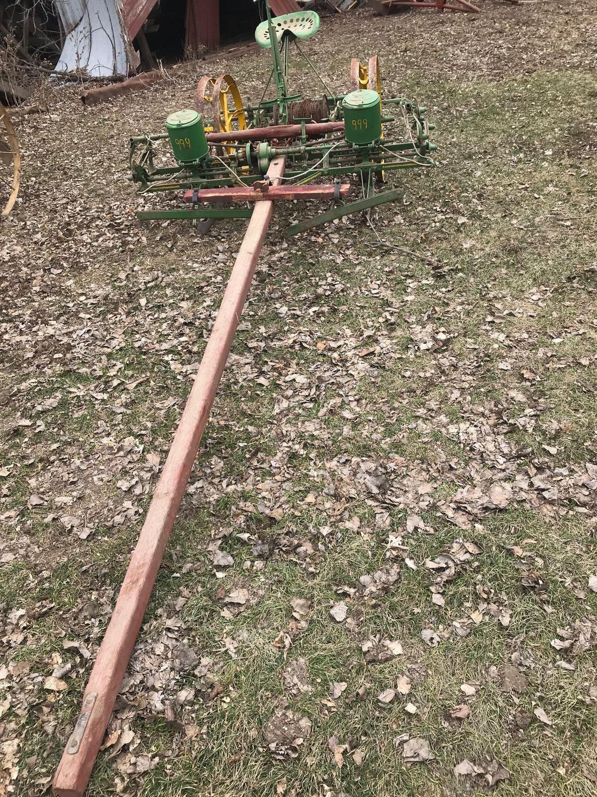 2 row horse drawn John Deere planter with wire check and cast iron John Deere container lids with