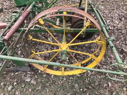 2 row horse drawn John Deere planter with wire check and cast iron John Deere container lids with