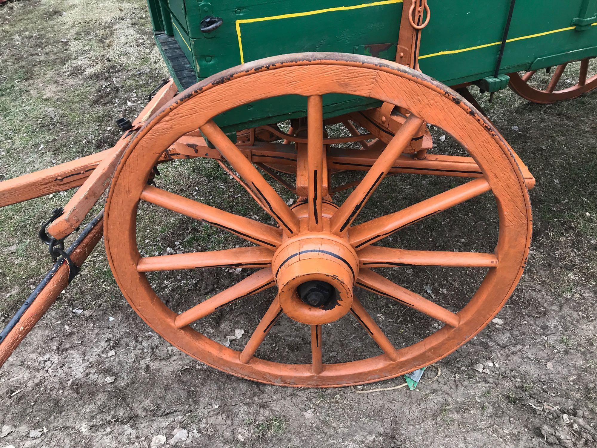 John Deere horse drawn wooden wagon. 3' x 10.5'. Wood spoke wheels (rears are 54", front are 44") In