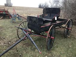 Two horse buck board with 2 person wood seat on wood spoke wheels. Box is 35"W x 8' 8"L. Rear wheels