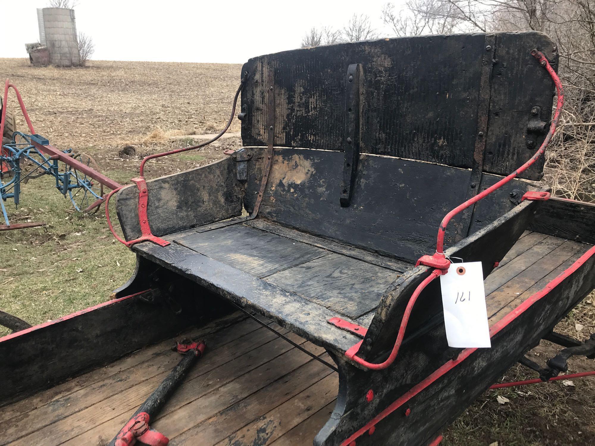 Two horse buck board with 2 person wood seat on wood spoke wheels. Box is 35"W x 8' 8"L. Rear wheels