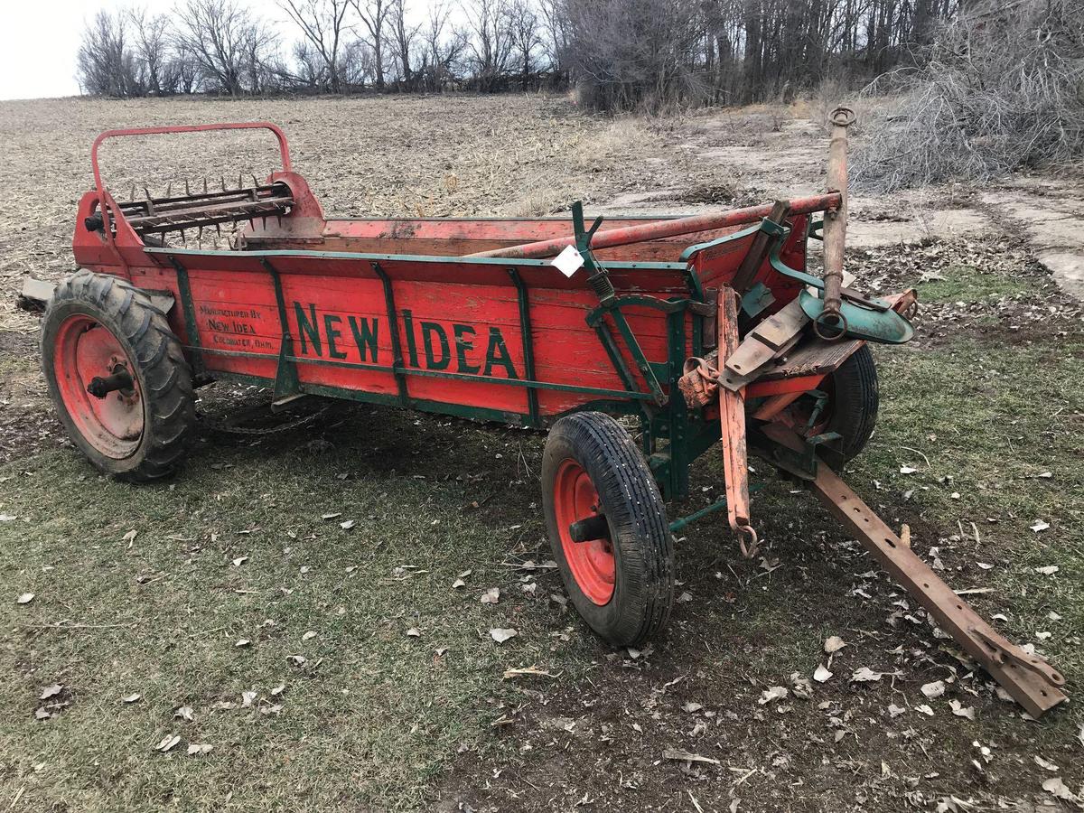 New idea horse drawn 4-wheel manure spreader with triple beaters, ground driven. Outside and