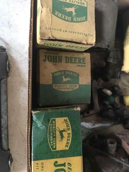 Various John Deere parts, boxes with 4 legged Deere, including bearings, and tractor parts