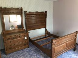 Solid oak, 2-piece ornate bedroom set to include a regular sized bed with ornate high headboard and