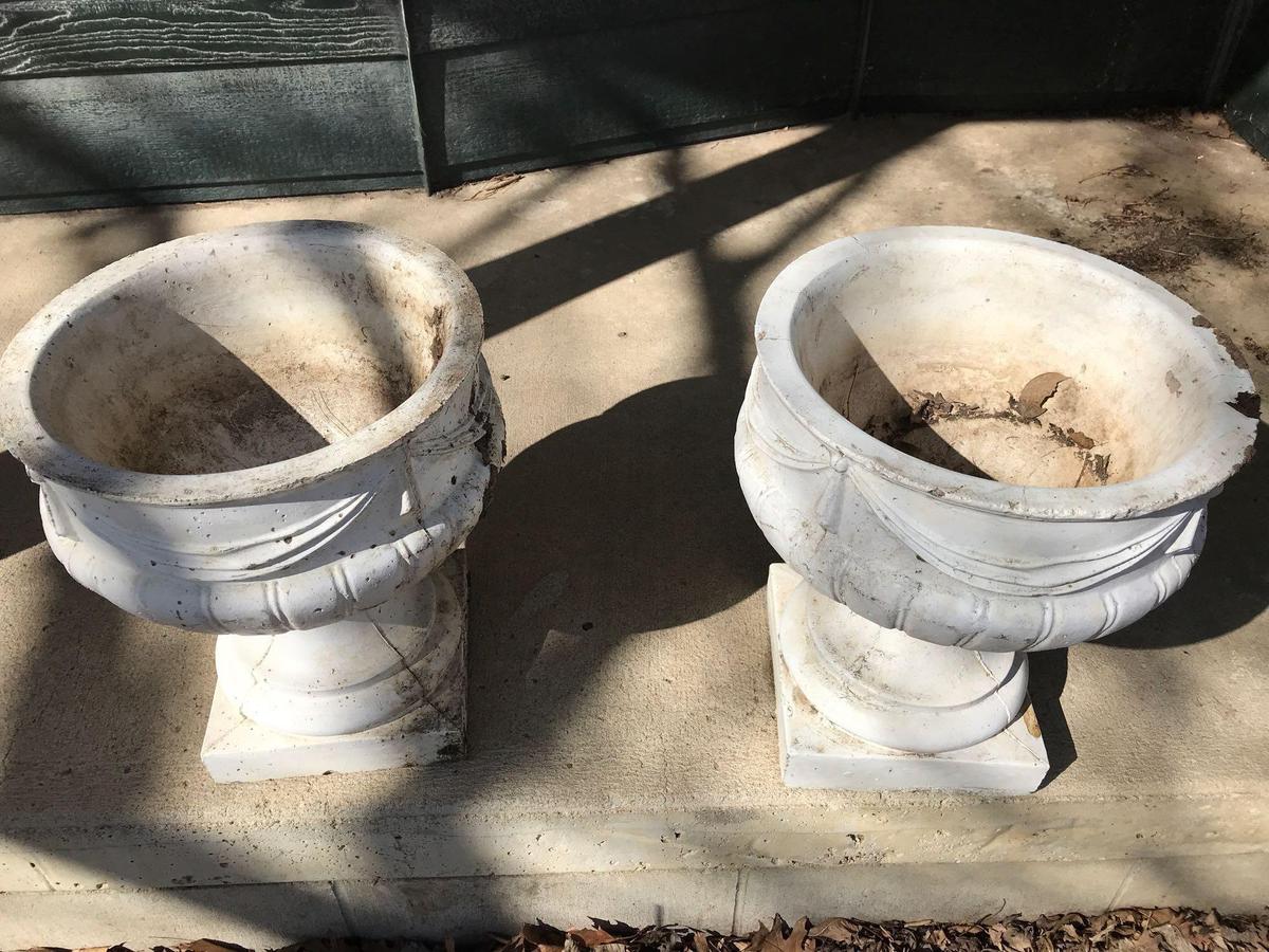 2 - 14"W x 17"H concrete flower pots. One has a chipped corner. No Shipping.