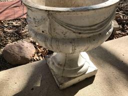 2 - 14"W x 17"H concrete flower pots. One has a chipped corner. No Shipping.