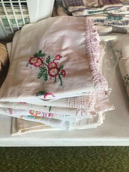 Various table cloths, flannel sheets, and decorative crocheted pillow cases.