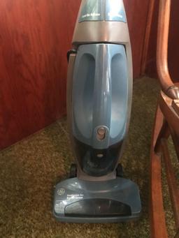 GE upright vacuum, a wood rocker, and wood plant stand