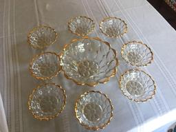 9'' diameter clear berry bowl with 8 matching smaller berry bowls all with gold trim.