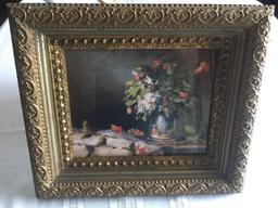 Very ornate frame with pictures of flowers