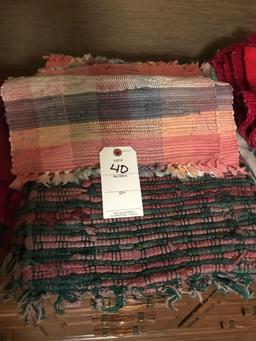 Various cloth placemats and napkins, rag rugs and cloth wall hanger