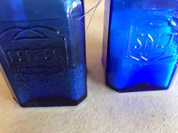 Blue glass large salt and pepper shakers, measuring cup and 2 shot glasses