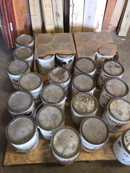 Pallet of various paints and stains.