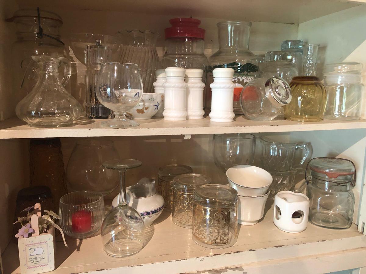Misc. glasses, lidded fruit jars, stem glasses, water pitcher and more.
