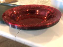 Plastic serving trays, oval plastic salad bowls, glass serving bowls and Tupperware cake lid.