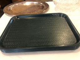 Plastic serving trays, oval plastic salad bowls, glass serving bowls and Tupperware cake lid.