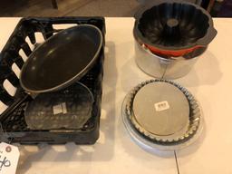 Plastic dish tray, cake molds, frying pan.