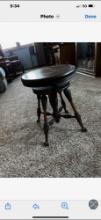 Piano stool with ball and claw feet.