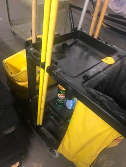 Rubbermaid janitor cart with assorted cleaning supplies and mop bucket