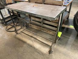 Rolling metal work table on casters.