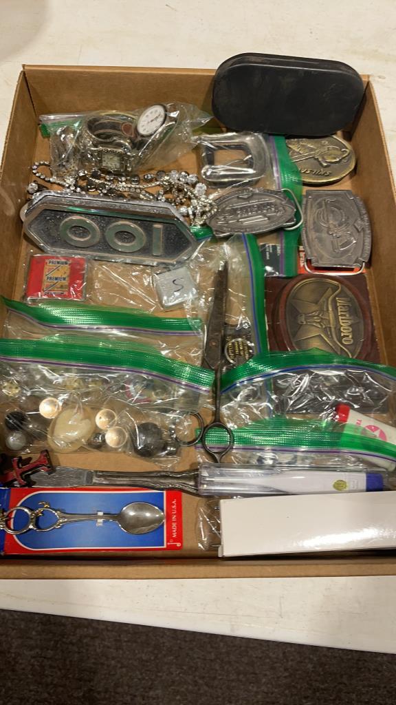 Box of belt buckles,costume jewelry, lighters, &