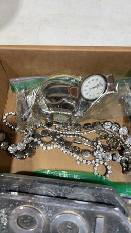 Box of belt buckles,costume jewelry, lighters, &