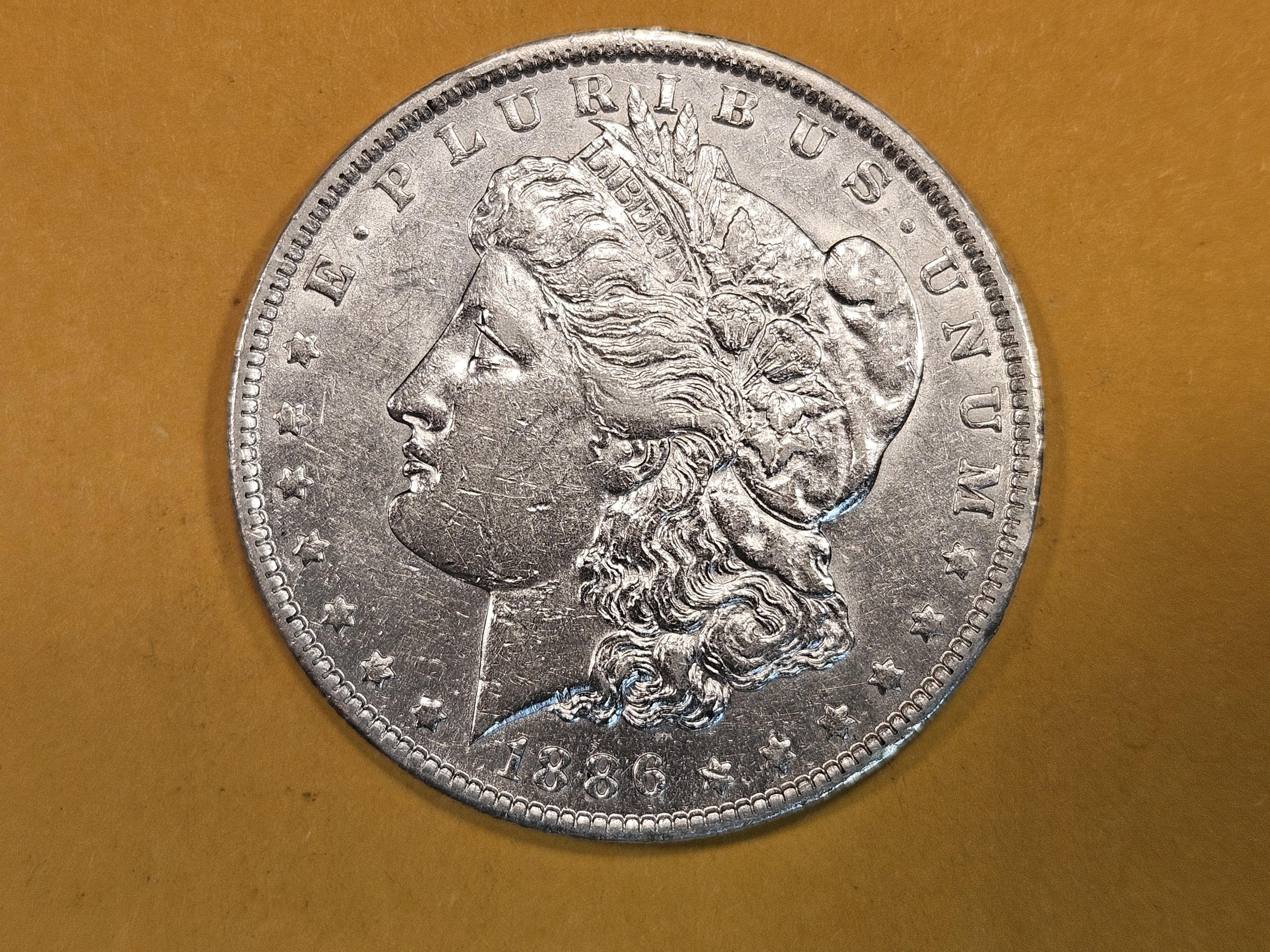 ** KEY GRADE! 1886-O Morgan Dollar in About Uncirculated plus