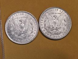 Two About Uncirculated Morgan Dollars