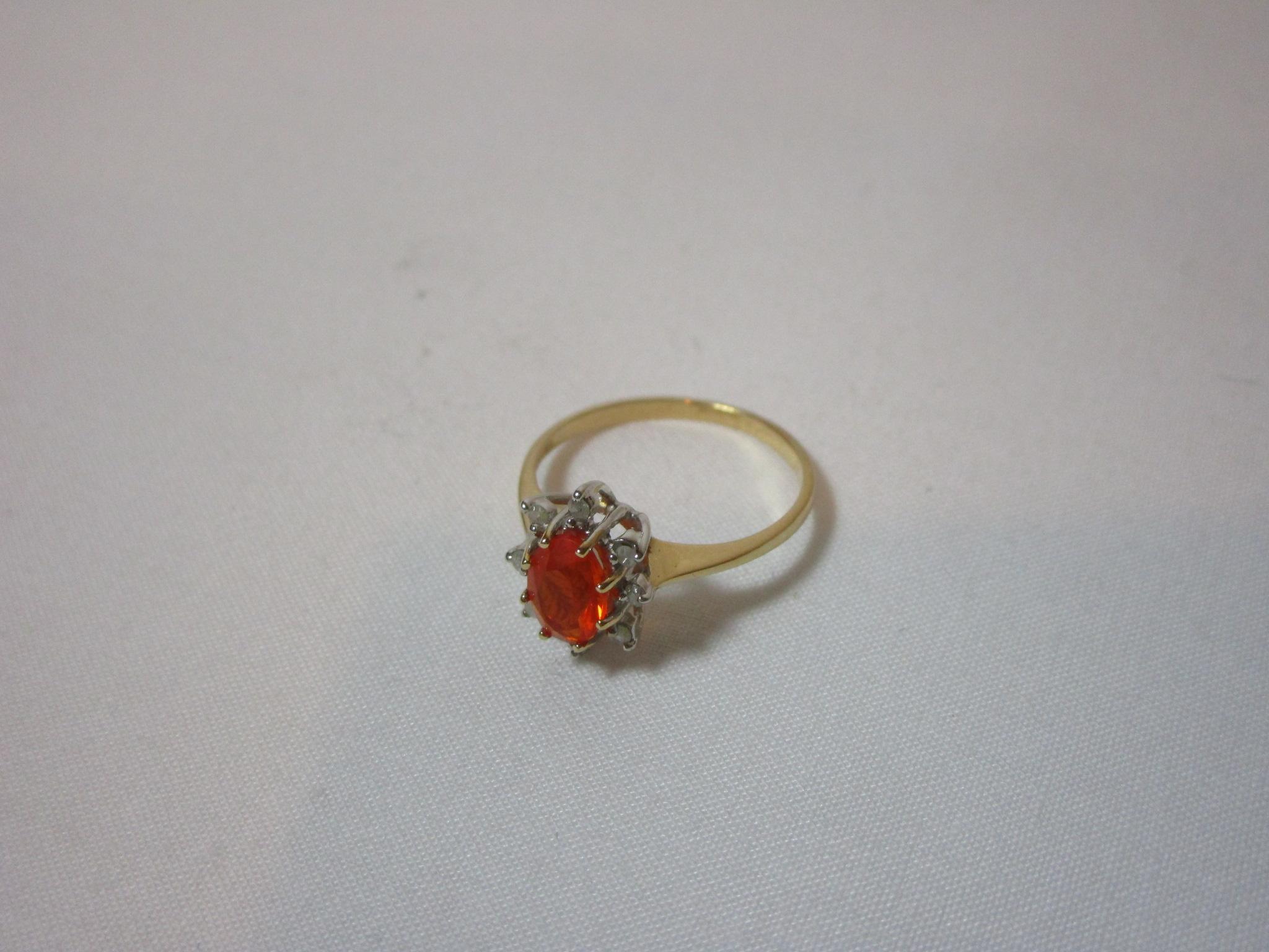 Oval Orange Opal w/ 8 Round Diamonds Mounted Around Opal. In 14k Yellow Gold Mounting
