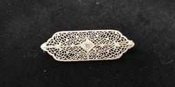 14 kt, w/g, filigree pin with one (1) .10 ct., diamond. Gold weight 4.74 gms.