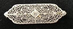 14 kt, w/g, filigree pin with one (1) .10 ct., diamond. Gold weight 4.74 gms.