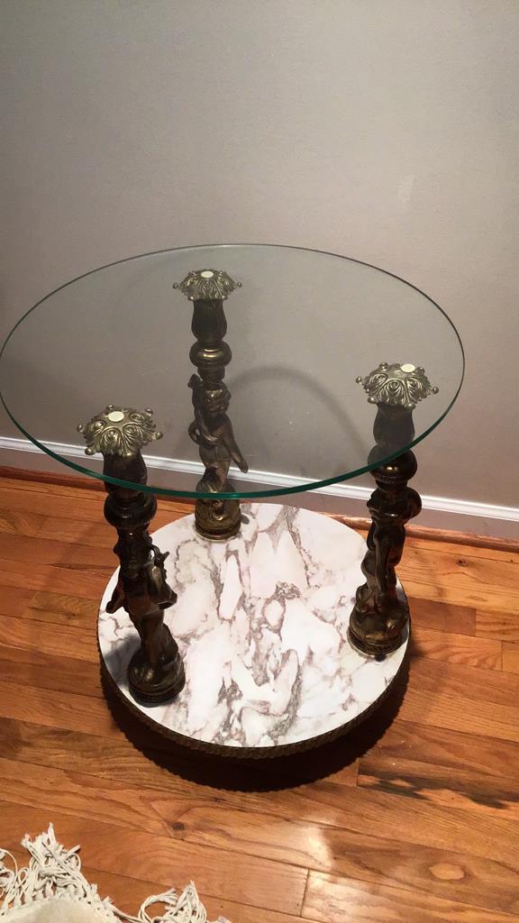 Glass top cherub motif end table.  22 inches