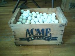 Wooden box full of golf balls