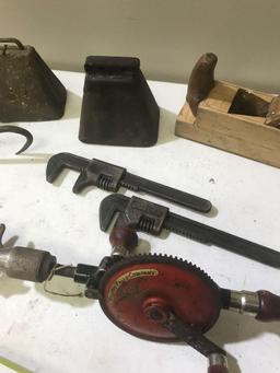 Cowbells, Millers Falls Drill, Wooden Plane, and 3 wrenches including one embossed with Ford